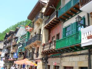 a group of buildings with balconies and an umbrella at iobo apartment in Rentería