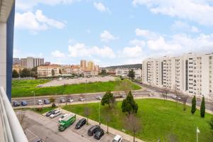 a view of a city with cars parked in a parking lot at Lisboa, Cidade, Elegant Apartment with Air Cond, Free WIFI and Near Metro, by IG in Lisbon