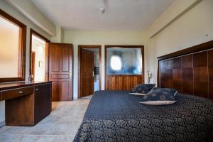 a bedroom with a bed with two pillows on it at Archontiko Liamas in Stavros