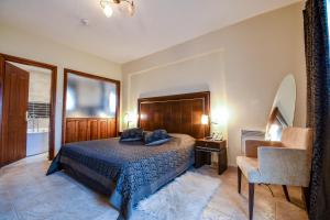 a bedroom with a bed and a chair at Archontiko Liamas in Stavros