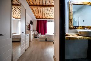 a bathroom with a sink and a mirror at Archontiko Liamas in Stavros