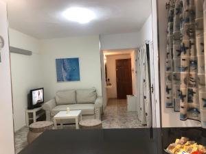 un soggiorno con un divano e un tavolo di Costa Las Maretas a Lomo de Arico