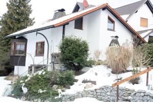 a white house with snow in front of it at Haus am Mühlberg in Fischbachtal