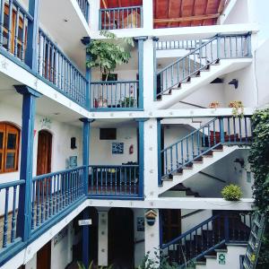 an apartment building with blue and white balconies at Doña Esther Otavalo in Otavalo