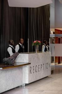 a group of men sitting at a reception desk at The Franklin Loft Apartments Johannesburg in Johannesburg