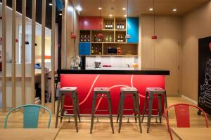 a red bar in a kitchen with stools at Stay Hotel Lisboa Centro Chiado in Lisbon