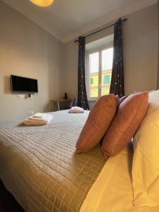 a bedroom with a bed with pillows and a window at Guest House Rome in Rome