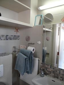 a bathroom with a sink and a mirror at Studio Ross, zonnig en gezellig en vlakbij de zee in Middelkerke
