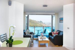 a living room with a view of the water at Millendreath at Westcliff - Self Catering flat with amazing sea views in Looe