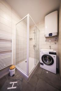 a bathroom with a washing machine and a washer at Allegro Exclusive Suite 2 with parking in Zadar