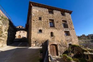 a large stone building with a gate in front of it at Casa el Francés in Graus