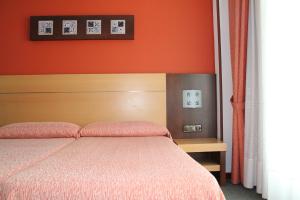 เตียงในห้องที่ Loop INN Hotel Santiago de Compostela