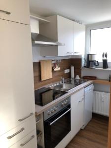 a kitchen with a sink and a stove top oven at Ferienwohnung Stadtflair in Daun