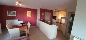 a living room with a table and a kitchen at Beau Site in Blankenberge
