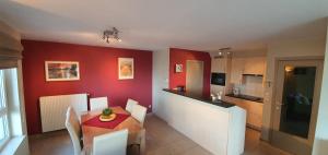 a kitchen and dining room with a table and chairs at Beau Site in Blankenberge
