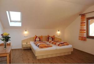 a bedroom with a bed with two pillows on it at Exenbacher Hof in Arnbruck