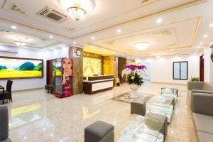 a living room with a couch and a tv at Diamond Hotel in Ninh Binh