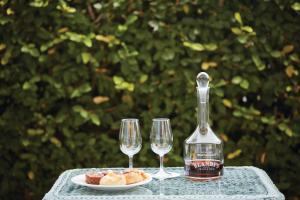 a table with two glasses and a bottle of wine at Reid's Palace, A Belmond Hotel, Madeira in Funchal