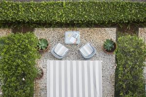 an overhead view of a patio with chairs and plants at Reid's Palace, A Belmond Hotel, Madeira in Funchal