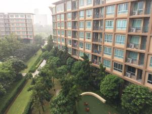 an apartment building with a park in front of it at Baan Tew Lom Condo บ้านทิวลมคอนโด in Cha Am