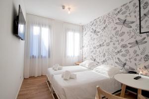 - une chambre avec 2 lits et une table dans l'établissement Hotel Rio, à Venise