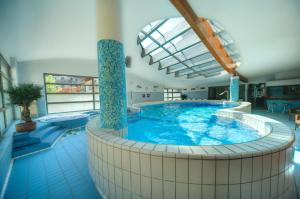 a large swimming pool in a large room at Hotel Lovec in Bled