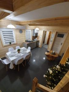 a kitchen and a dining room with a table and chairs at Apartamenty Jaworzynka in Jaworzynka