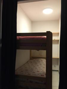 a small room with a bunk bed in a room at Appartement Solférino in Luz-Saint-Sauveur