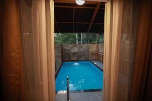 a view of a swimming pool through a door at GoGo Land Resort & Adventurous Sports in Pūvār