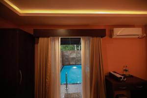 a room with a window and a swimming pool at GoGo Land Resort & Adventurous Sports in Pūvār