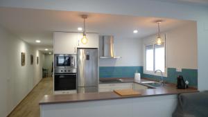 a kitchen with a refrigerator and a counter top at Living Triana House in Seville