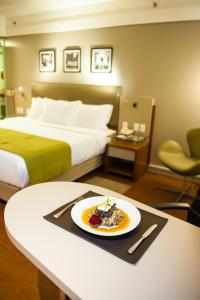 a plate of food on a table in a hotel room at Quality Porto Alegre in Porto Alegre