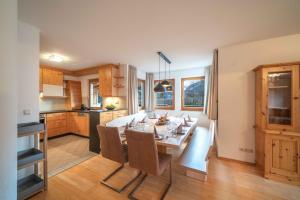 a kitchen and dining room with a table and chairs at Landhaus Kalvarienberg in Ladis