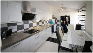 a kitchen with white cabinets and a counter top at Mikelin in Primošten