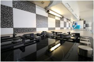a kitchen with black and white tiles on the wall at Mikelin in Primošten