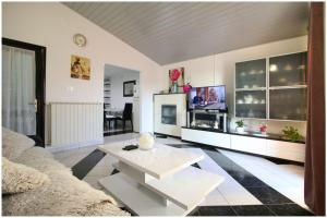 a living room with a couch and a table at Mikelin in Primošten
