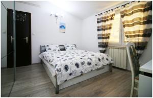 a small bedroom with a bed and a window at Mikelin in Primošten +15 photos