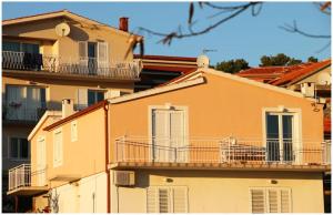 a dog sitting on a balcony of a building at Mikelin in Primošten