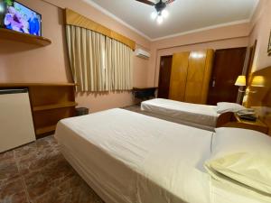Postel nebo postele na pokoji v ubytování Ideal Praia Hotel