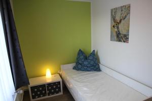 a small room with a bed with a lamp on it at Wohnung Julius 6 in Sankt Andreasberg