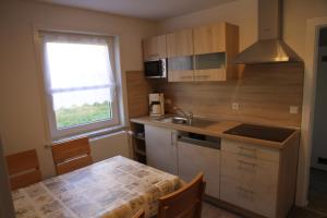 a small kitchen with a table and a sink at Wohnung Julius 6 in Sankt Andreasberg