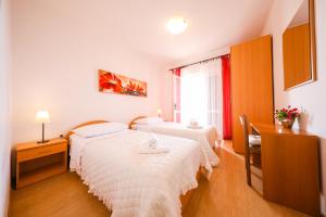 Ένα ή περισσότερα κρεβάτια σε δωμάτιο στο Apartments Zvjezdana