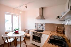 a kitchen with a table and a small table with chairs at House of the Golden Horse in Hosszúréti Lovas Major in Törökbálint