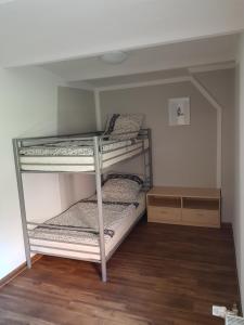 two bunk beds in a room with wood floors at Ferienhaus Sooß in Heiligengrabe