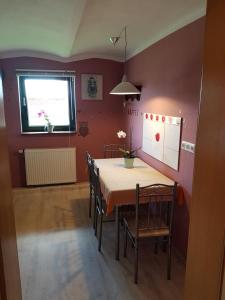a dining room with a table and chairs and a window at Ferienhaus Sooß in Heiligengrabe