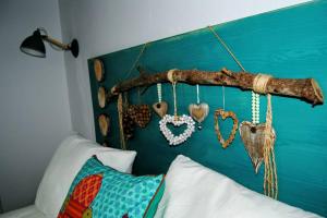 Arabias Loft Caños de Meca في لوس كانيوس دي ميكا: غرفة نوم مع سرير مع قلوب معلقة على اللوح الأمامي