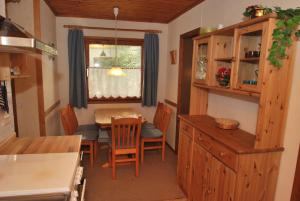 a kitchen and dining room with a table and chairs at Ferienhaus Kamin in Clausthal