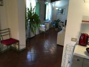 a living room with a red chair and a floor at Appartamento Il Glicine in Pistoia