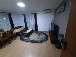 a living room with a couch and a tv at privatni smestaj Dobri in Bujanovac +3 photos