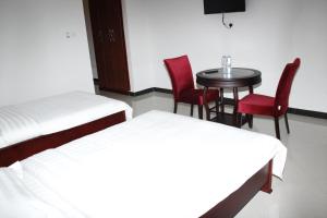 Postel nebo postele na pokoji v ubytování Kenlon Hotel Kampala